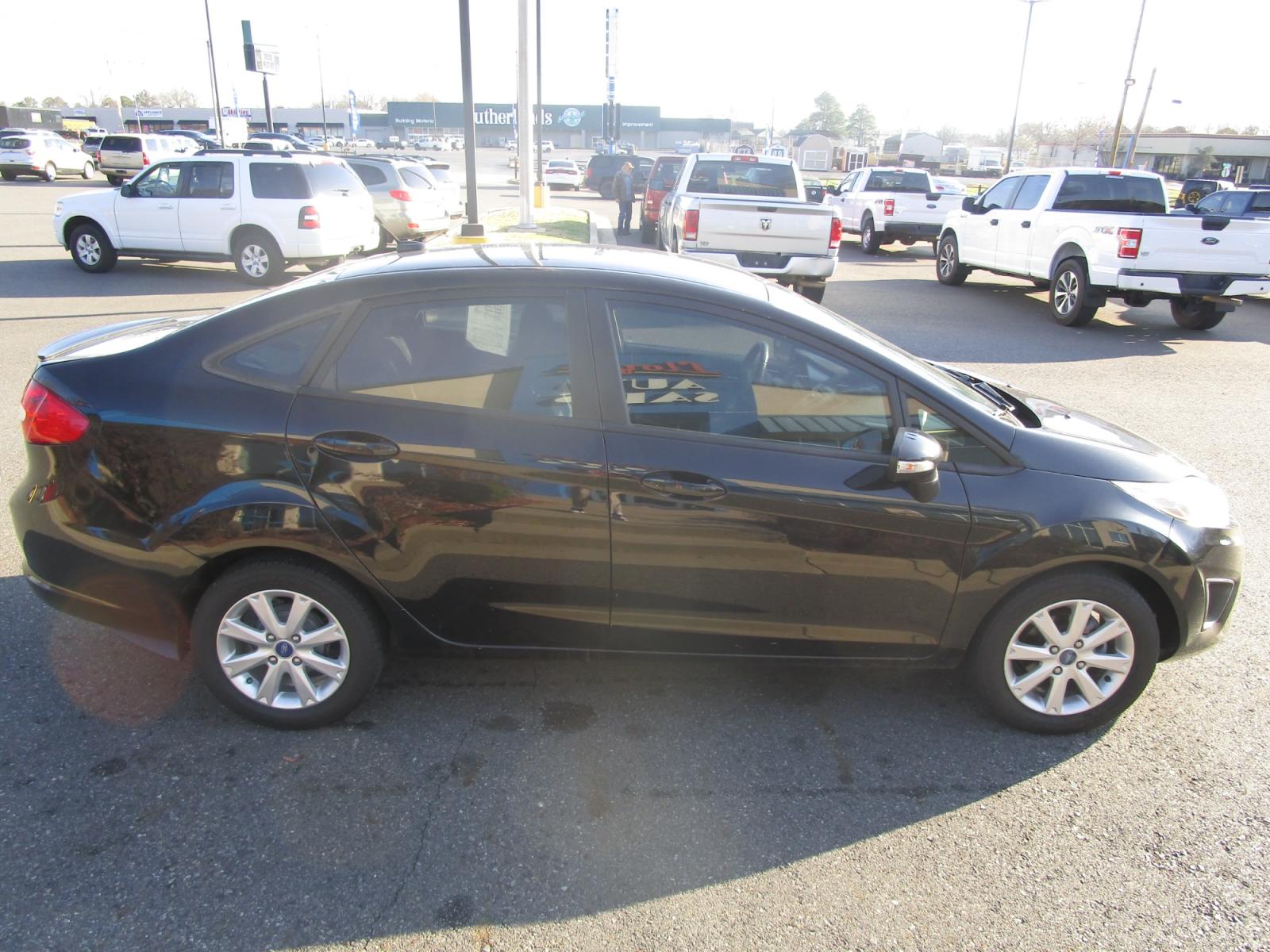 2013 BLACK /Black / Cloth Ford Fiesta SE Sedan (3FADP4BJ5DM) with an 1.6L L4 DOHC 16V engine, located at 1814 Albert Pike Road, Hot Springs, AR, 71913, (501) 623-1717, 34.494228, -93.094070 - Photo #2